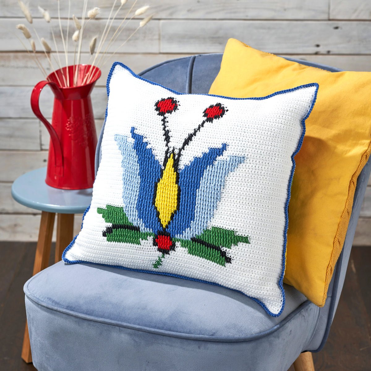 Decorative pillow with a floral pattern on a blue chair