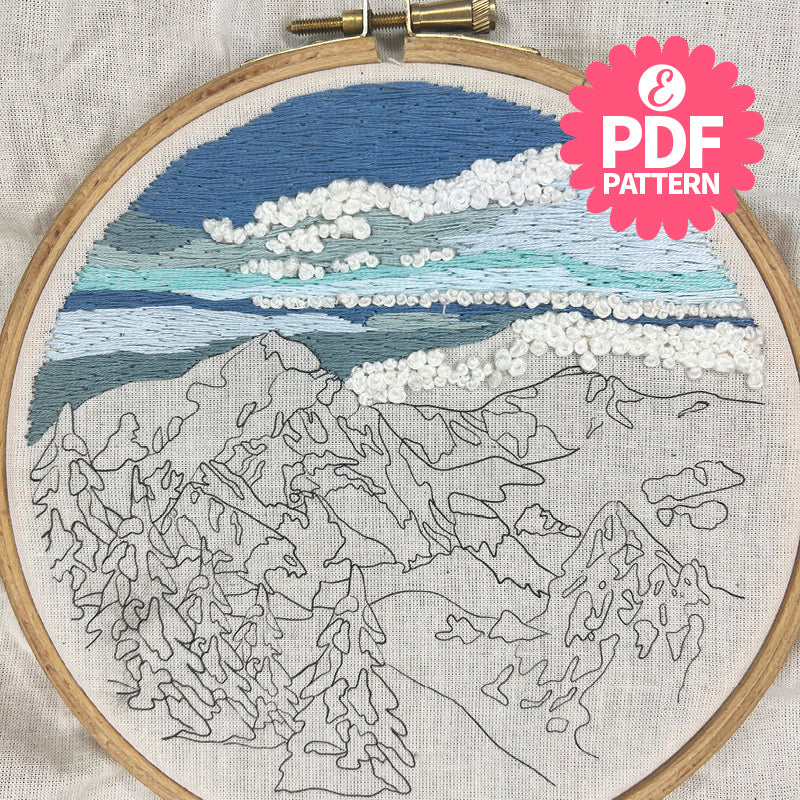 Embroidery hoop with mountain landscape design and PDF pattern label.