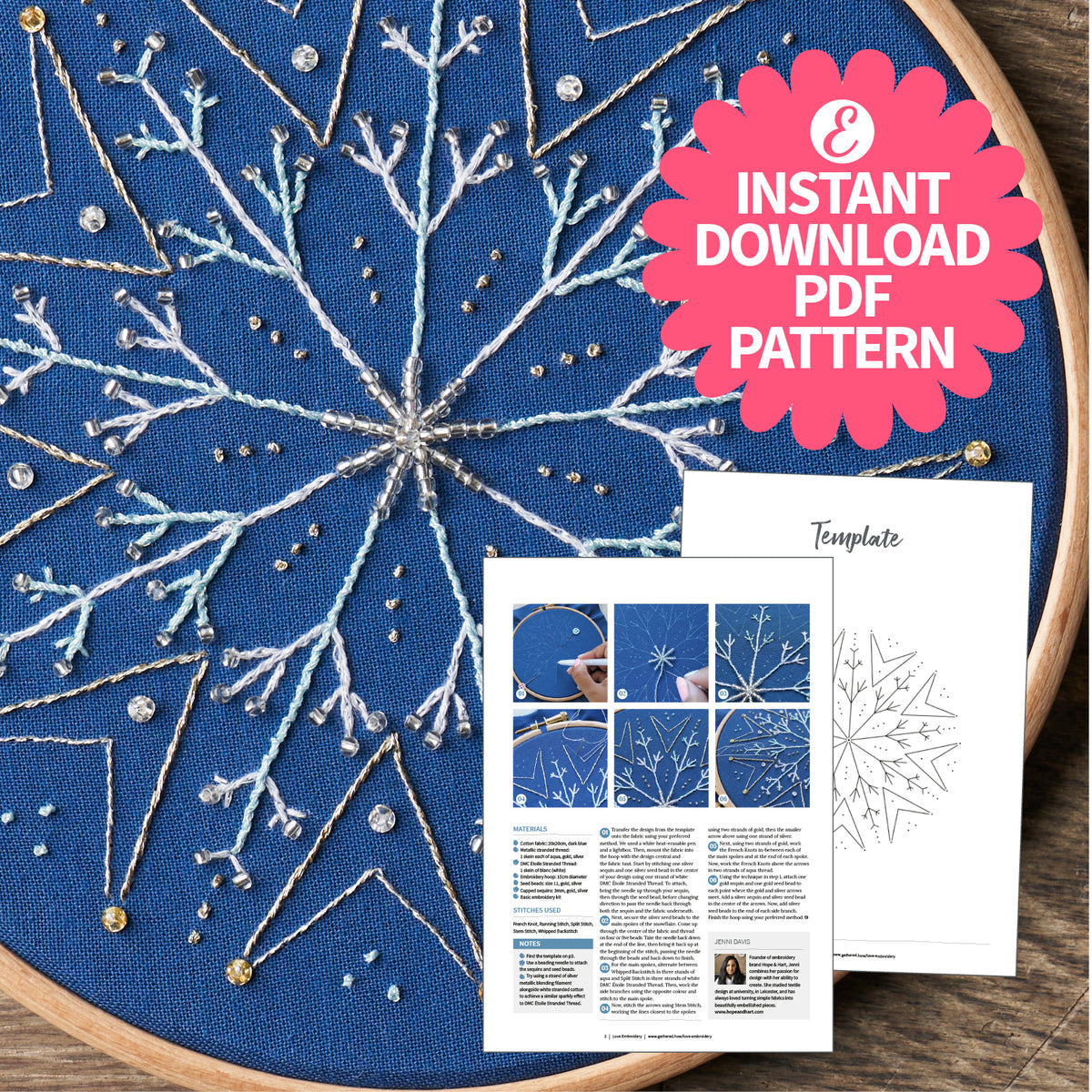 Embroidery hoop with blue fabric featuring a snowflake pattern and an instant download PDF pattern on a wooden surface.