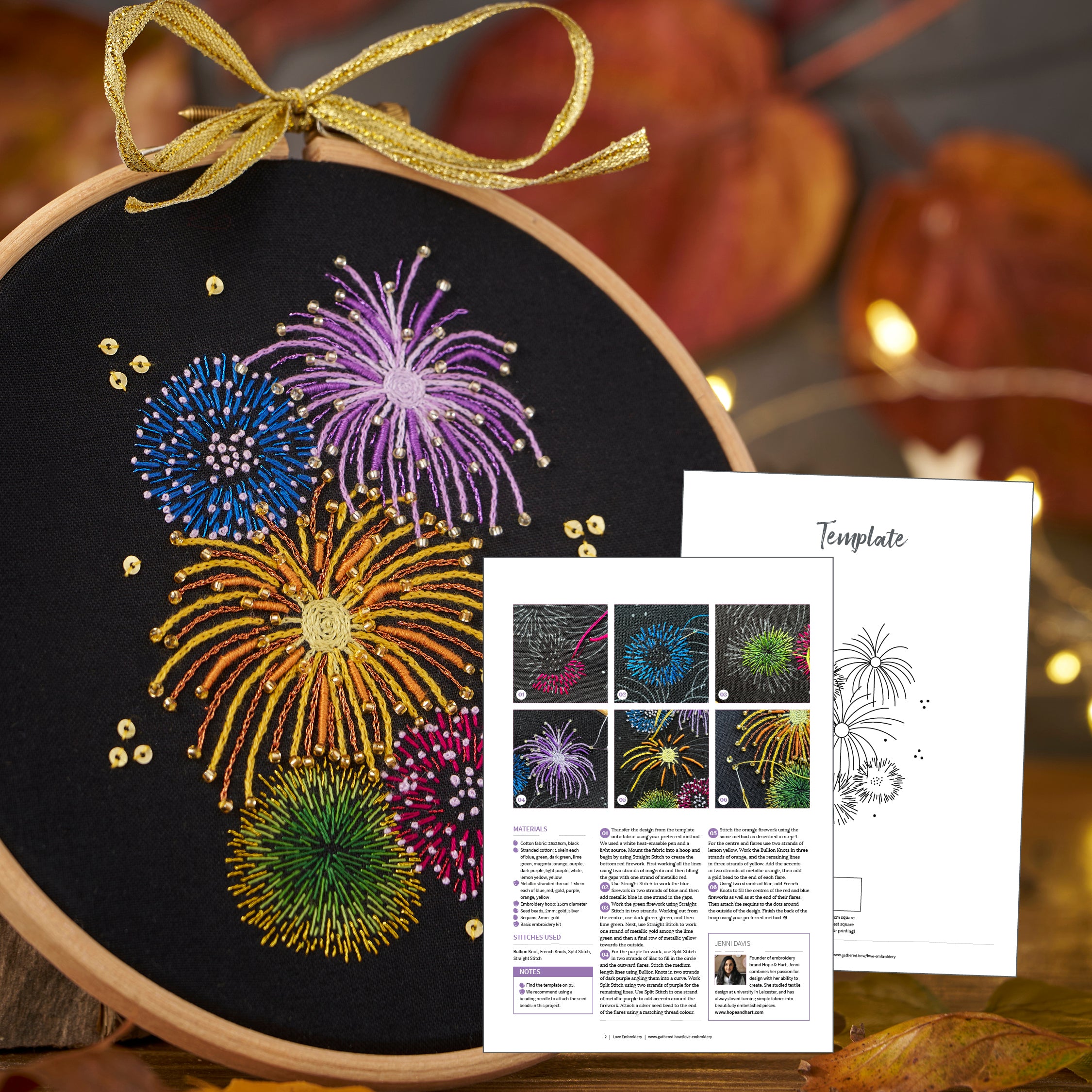 Embroidery hoop with embroidered fireworks design and template leaflet on a festive background.