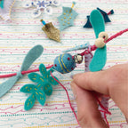 Handmade felt decorations on a colorful fabric background