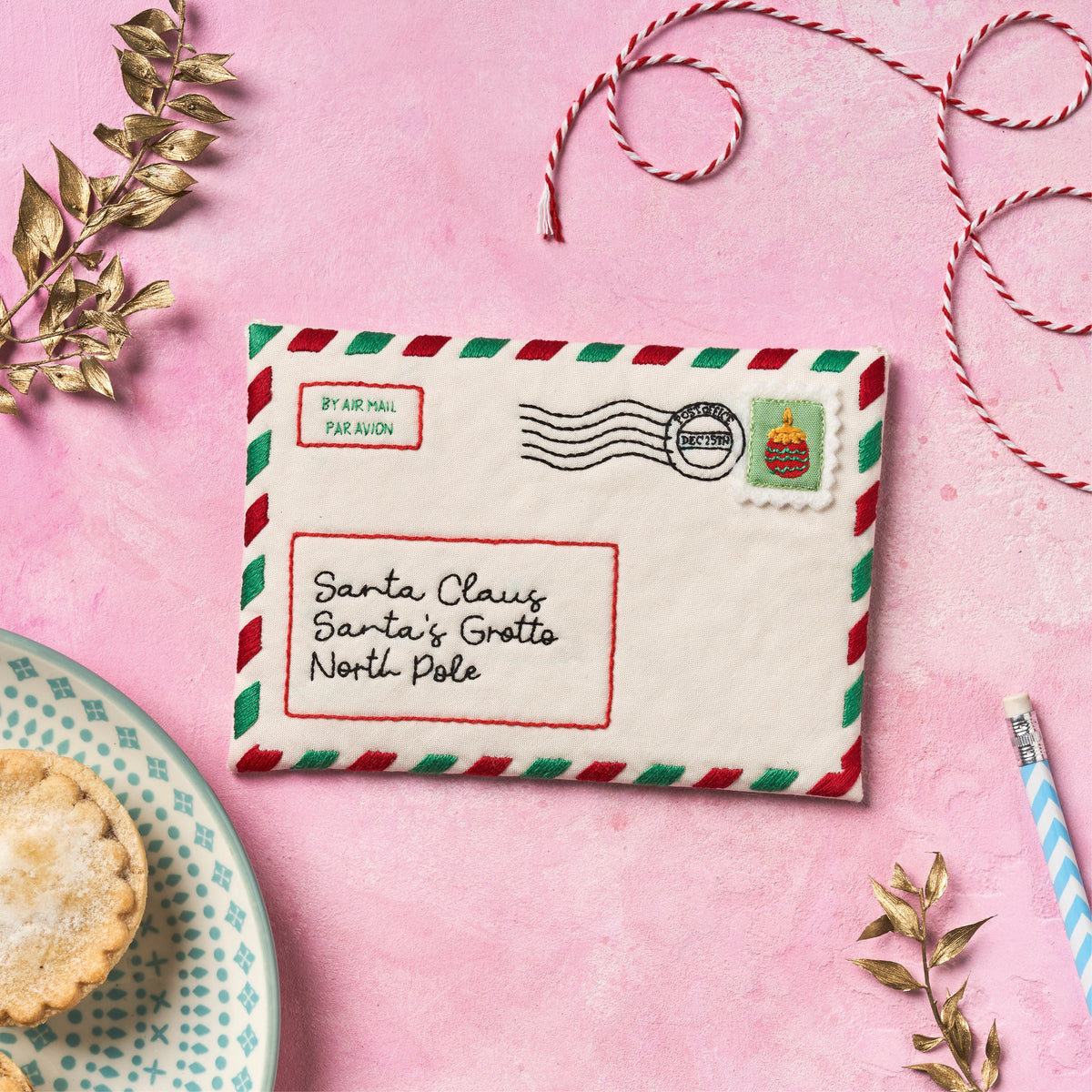 Decorative letter to Santa Claus on a pink background with festive elements.