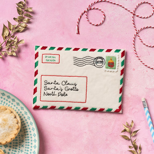 Decorative letter to Santa Claus on a pink background with festive elements.