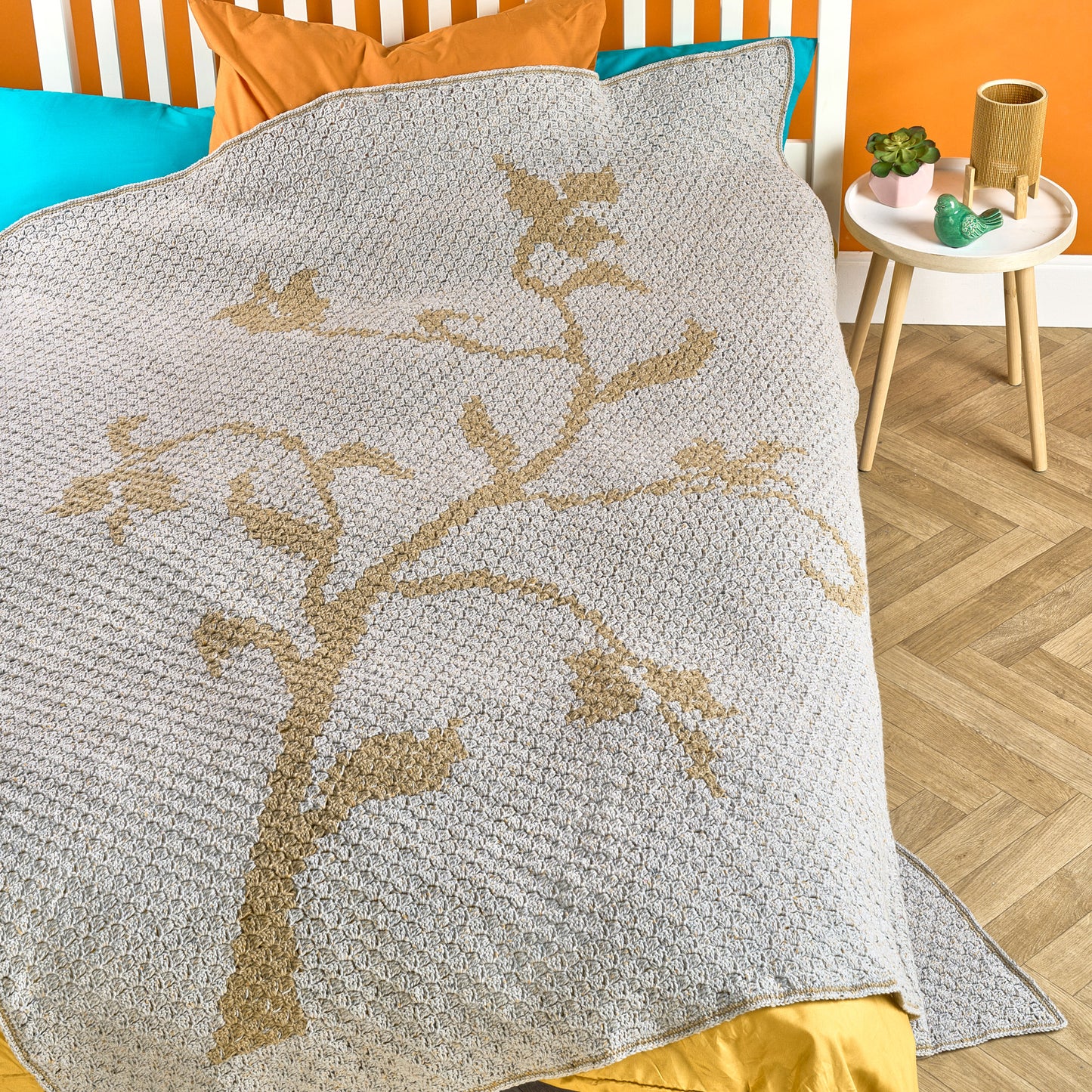 Textured blanket with floral pattern on a bed in a bedroom setting