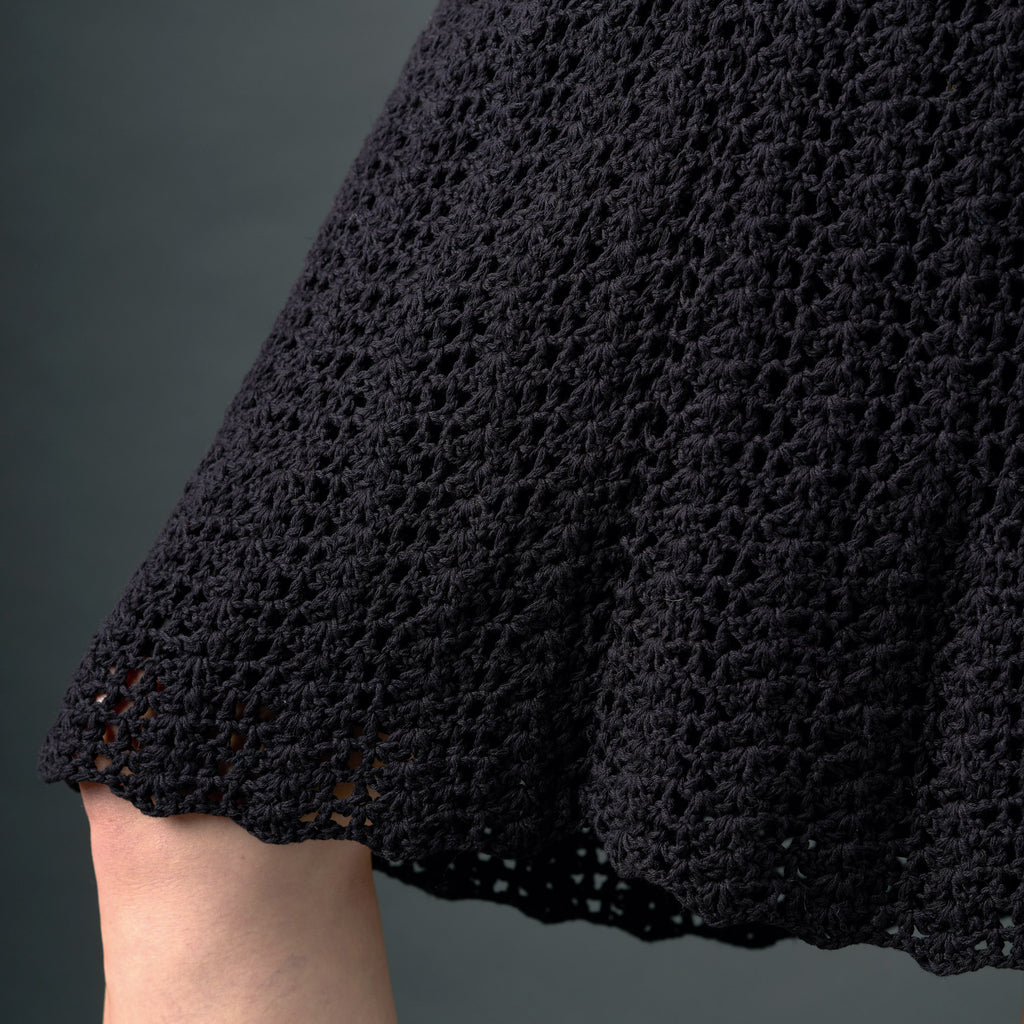 Close-up of a black lace garment on a dark background