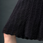 Close-up of a black lace garment on a dark background
