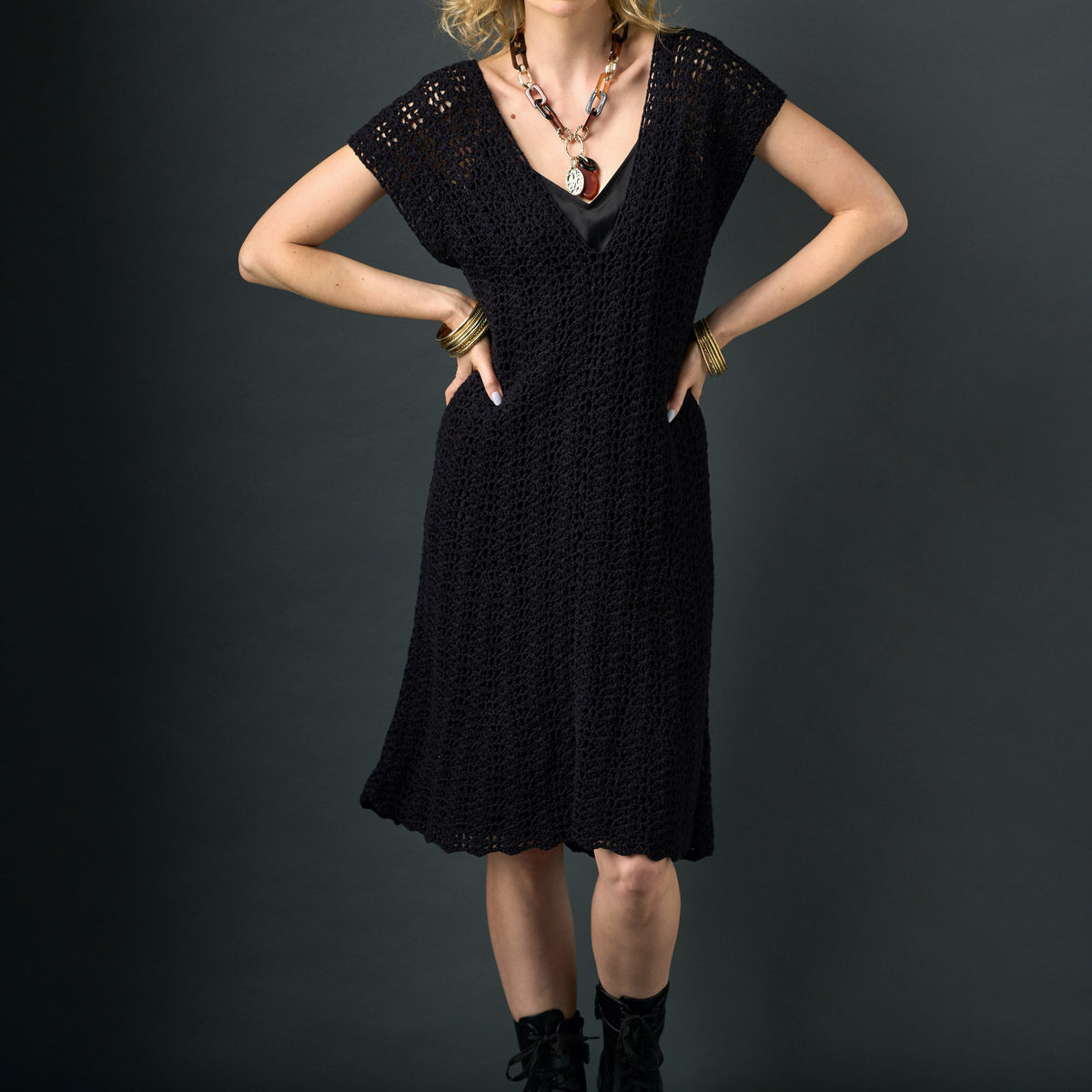 Woman wearing a black dress with a dark background
