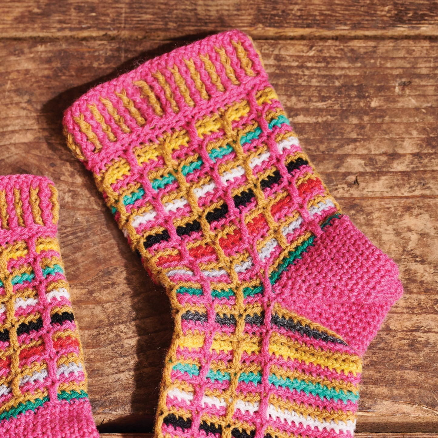 Colorful knitted socks on a wooden surface