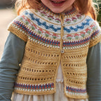 Child wearing a colorful knitted cardigan with a patterned border.