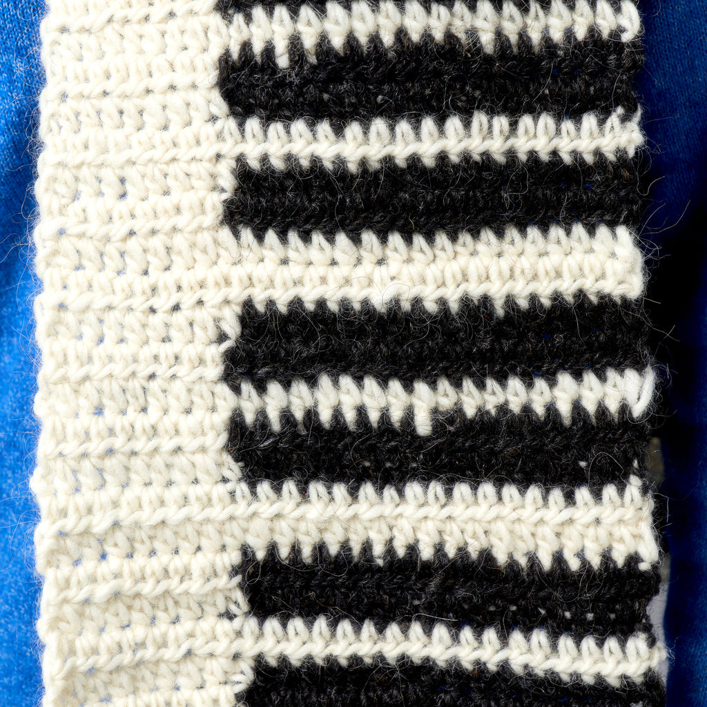 Close-up of black and white striped fabric on a blue background