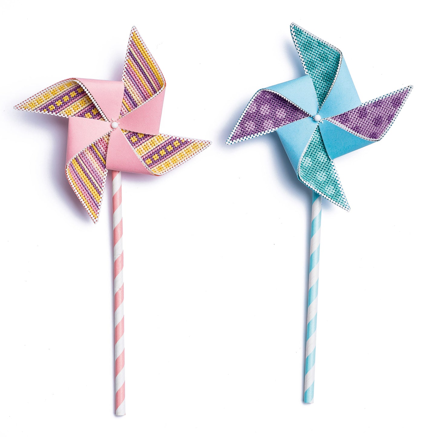 Two colorful paper pinwheels on sticks against a white background