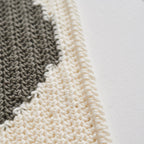 Close-up of a textured rug with a geometric pattern on a white background