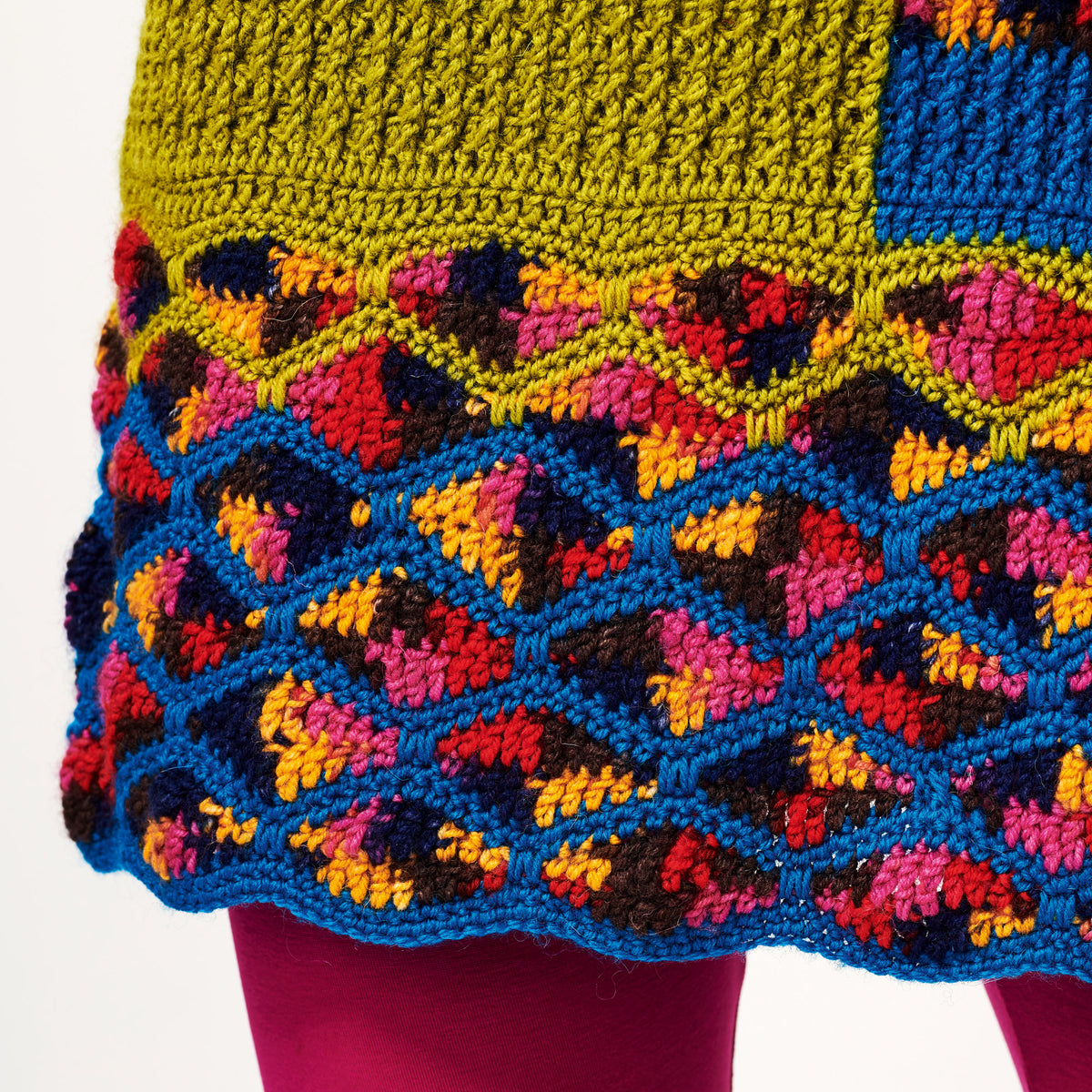 Colorful crocheted fabric with a geometric pattern on a white background