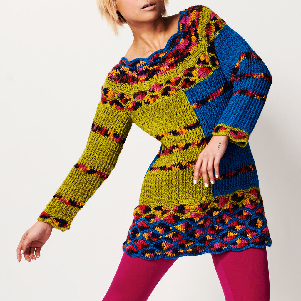 Colorful crochet dress with geometric pattern worn by a person on a white background