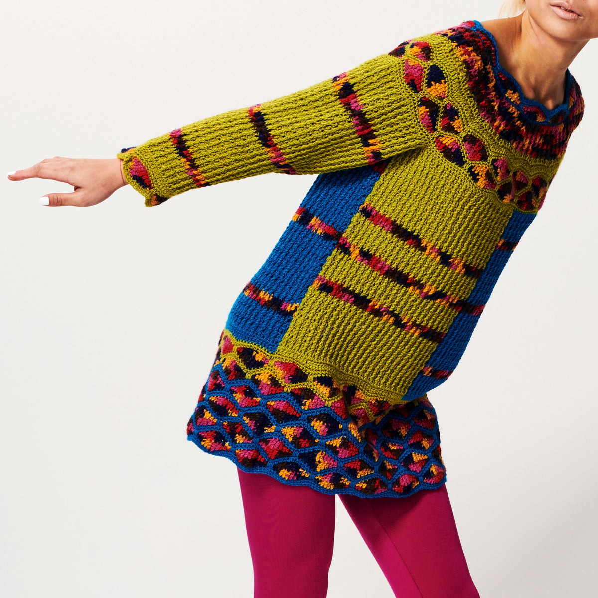 Colorful crochet dress with geometric pattern on a white background