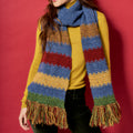 Person wearing a colorful striped scarf against a red background