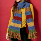 Person wearing a colorful striped scarf against a red background