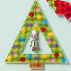 Triangular ornament with colorful pattern and bell on a light blue background
