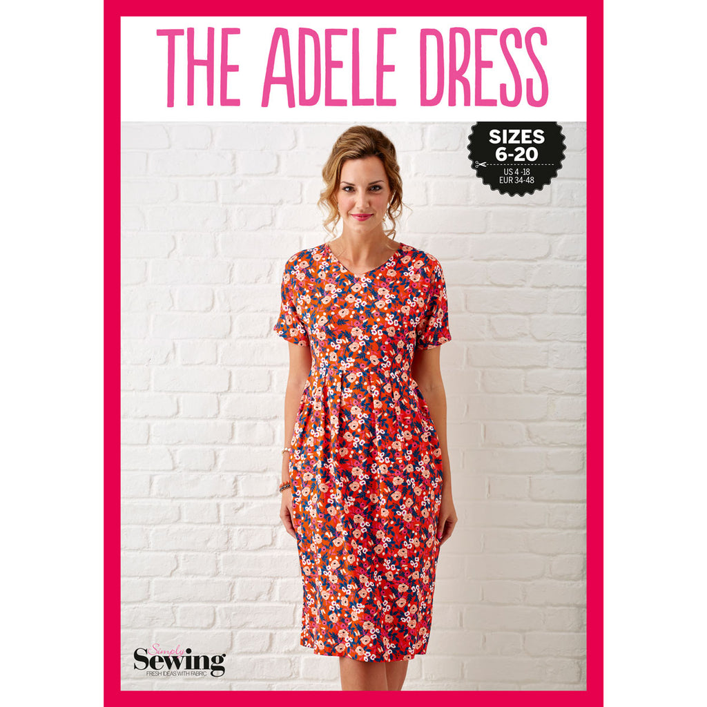 Woman wearing a bright floral dress stands against a white brick wall. "The Adele Dress" is printed above. Sizes 6-20 and a sewing logo are visible. Vibrant and cheerful mood.

