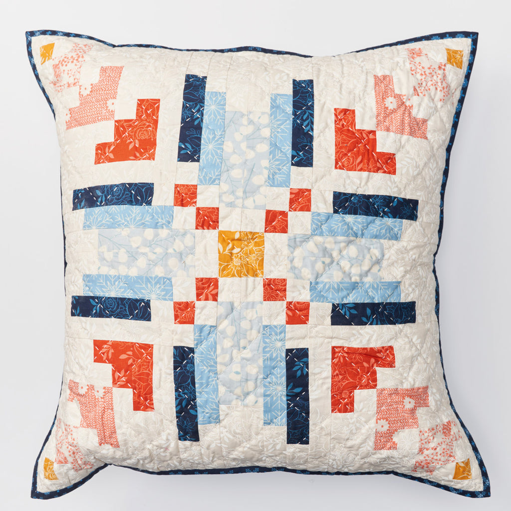 Quilted pillow with geometric pattern on a white background