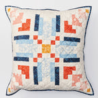 Quilted pillow with geometric pattern on a white background