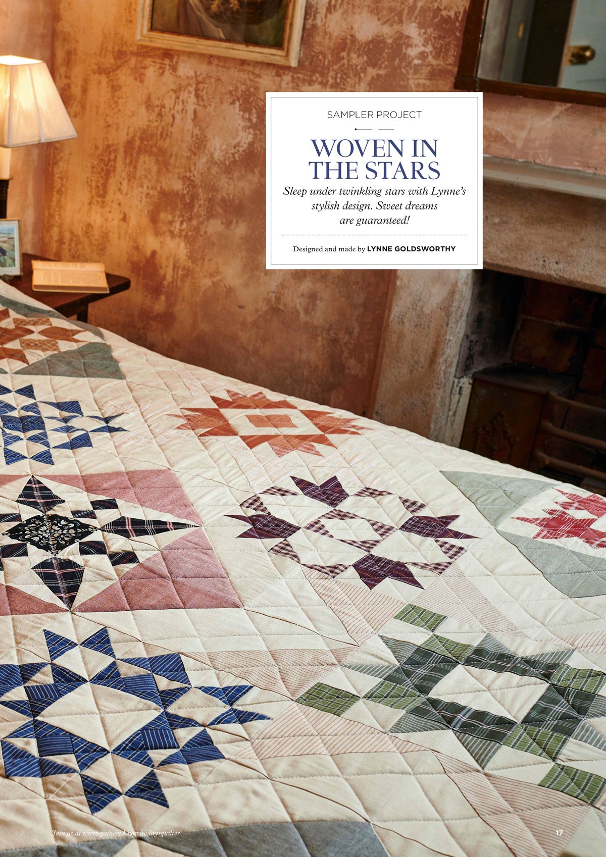 Quilt on bed with varied star patterns in blue, pink, green, and brown. Cozy room with earthy tones, soft lighting, and rustic walls. Warm, inviting ambiance.