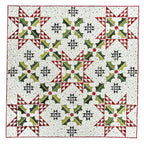 Quilt with geometric pattern featuring green, red, and black on a white background