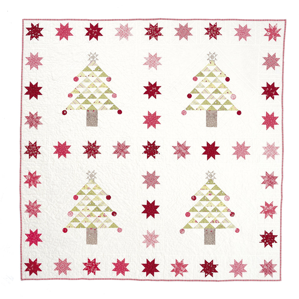 Quilt with Christmas tree and star pattern on a white background