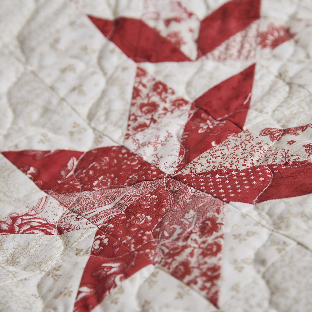 Close-up of a red and white quilt with star pattern