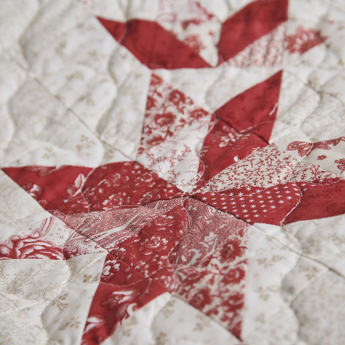 Close-up of a red and white quilt with star pattern