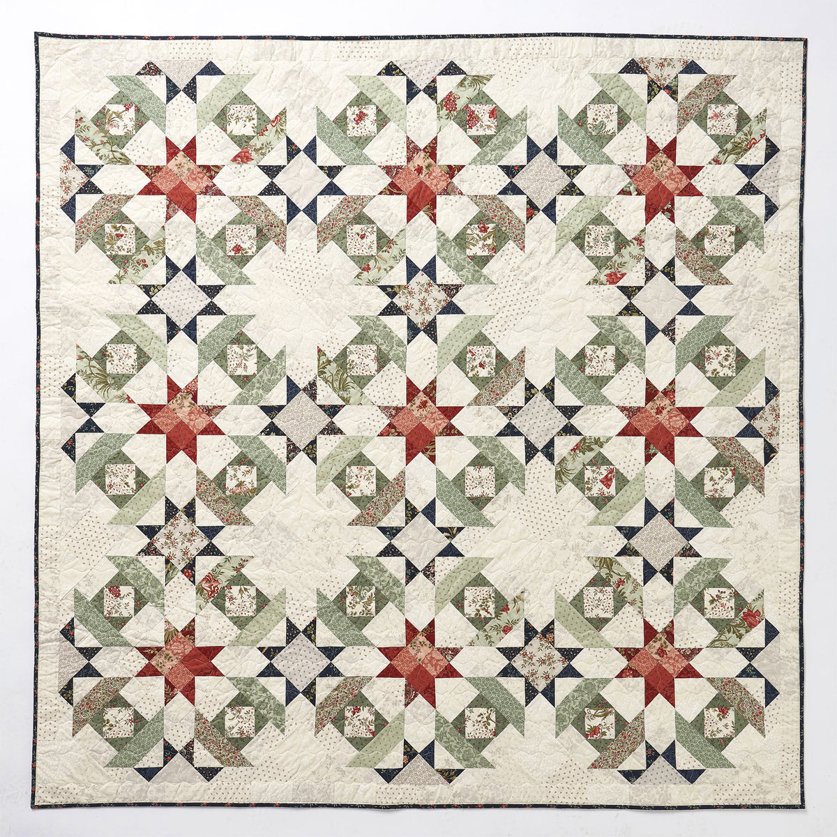 Quilt with star pattern on a white background