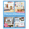 Promotional image for The Joy of Kindness Cross Stitch Collection PDF, featuring finished cross stitch projects with various designs including animals, patterns, and text messages on fabric.