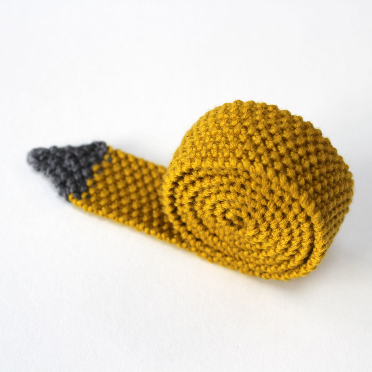 A rolled up yellow skinny knitted tie