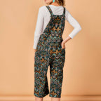 Person wearing a patterned overalls on a beige background