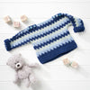 Blue and white striped baby sweater with a teddy bear and wooden blocks on a light wooden surface