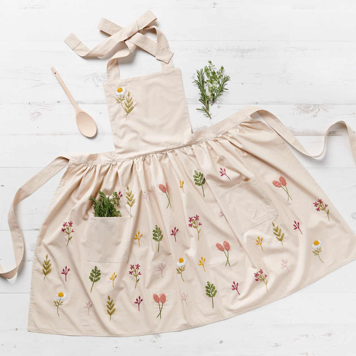 apron with floral patterns on a white wooden surface