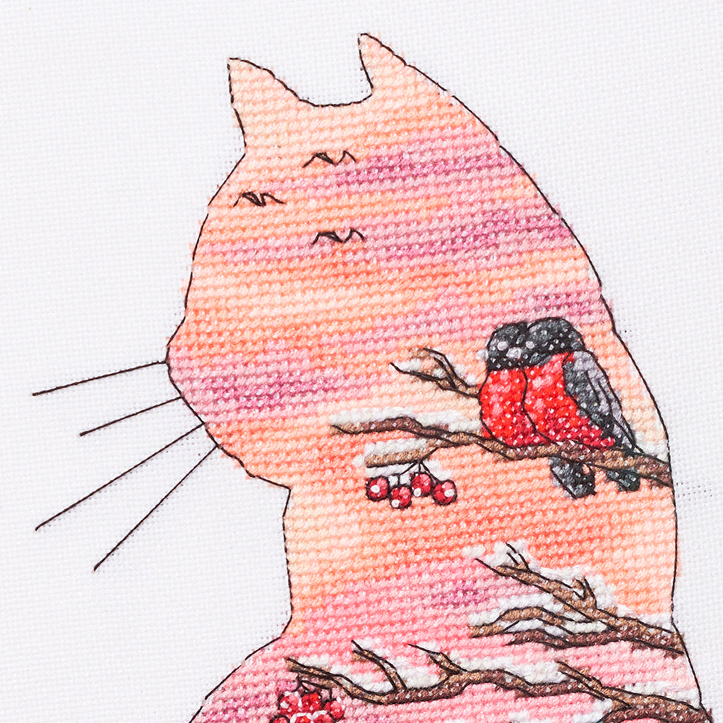 Cross-stitched design of a cat with a bird on a branch