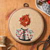 Embroidery hoop with floral design on a wooden surface