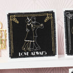 Embroidered patch with dancing couple and 'Love Always' text on a black background.
