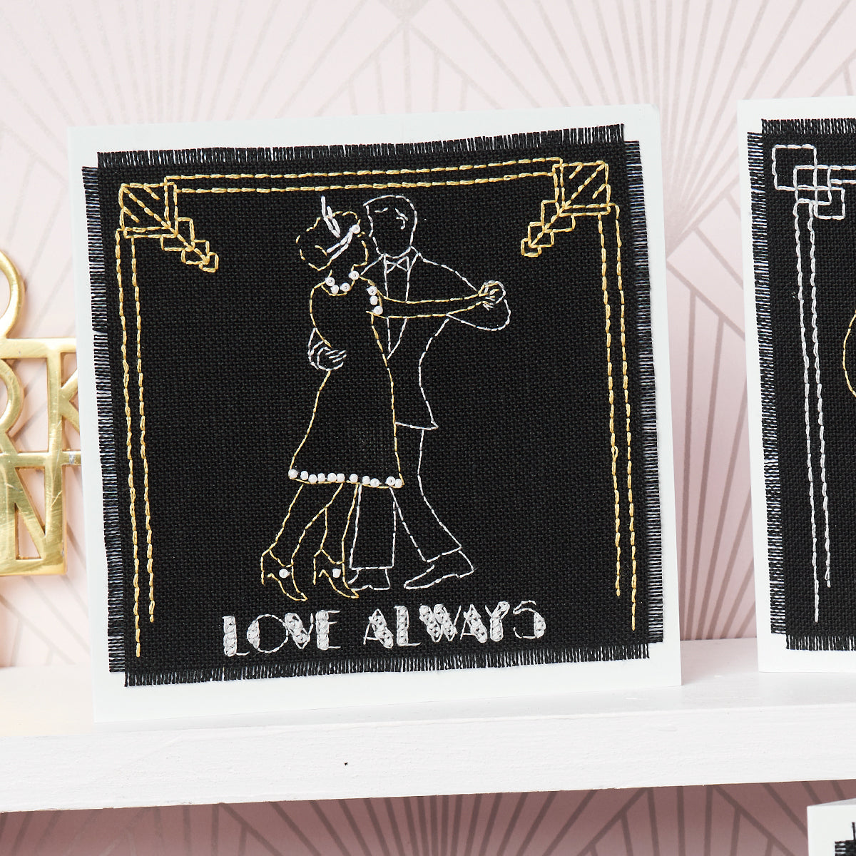 Embroidered patch with dancing couple and 'Love Always' text on a black background.