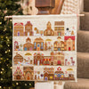 Cross-stitched advent calendar with gingerbread houses and numbers, hanging against a neutral background.