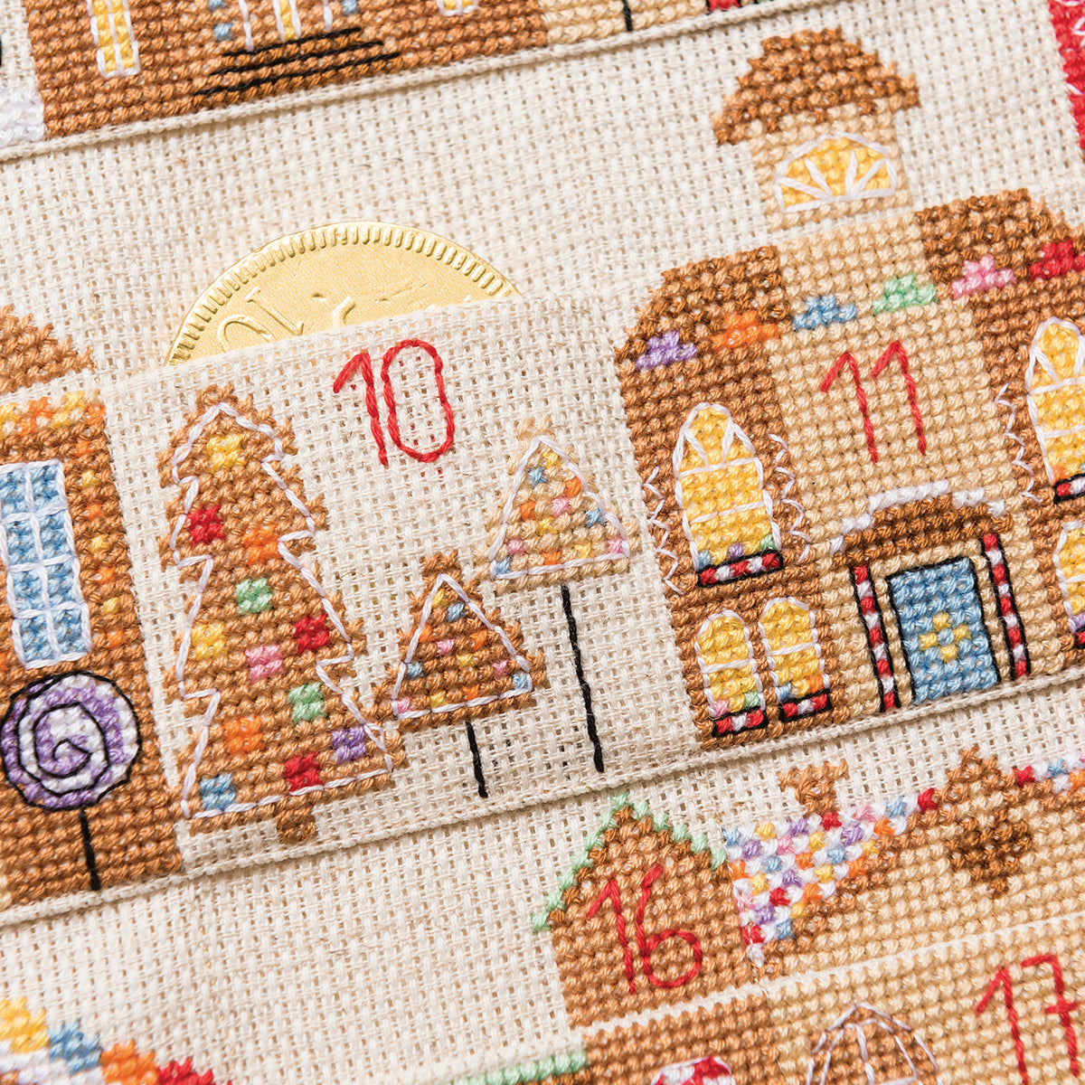 Cross-stitched advent calendar with gingerbread houses and numbers