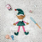 Elf doll with kitchen utensils on a patterned tile background
