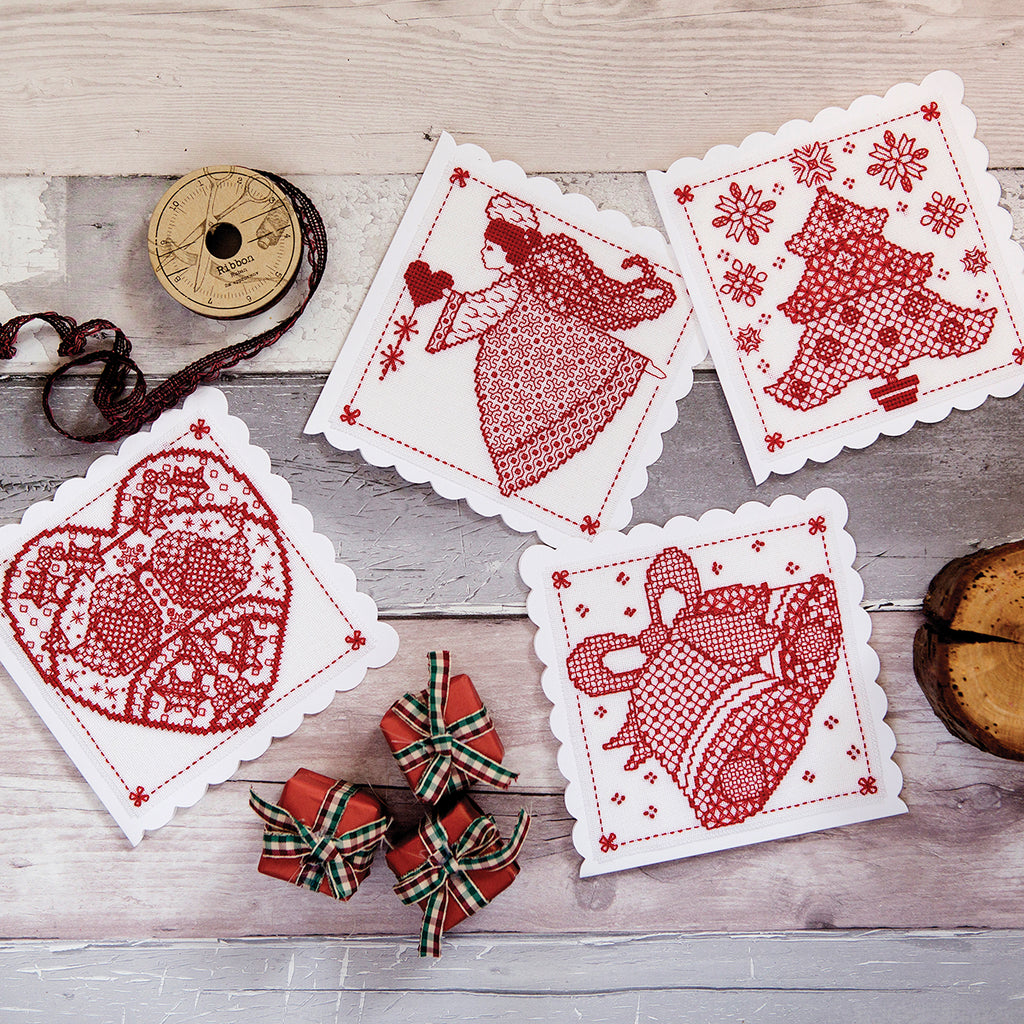 Decorative cards with red patterns on a wooden surface