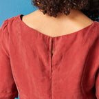 Red blouse with a plain background